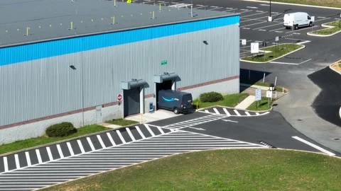 Amazon van drives into warehouse distribution center. Aerial of warehouse Stock Footage 239374800