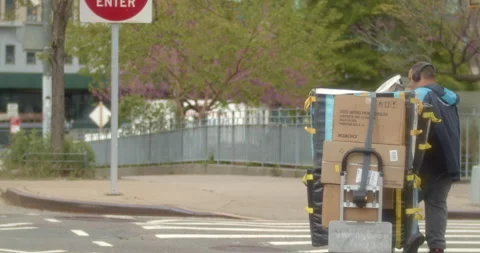 Amazon Worker Delivering Packages in Manhattan Stock Footage 239498552