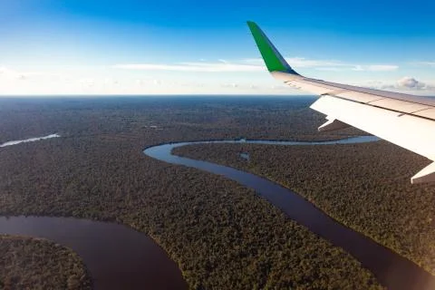 Amazonas river, view from the plane, wing of the plane, travel concept. Stock Photos