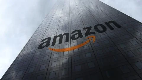 Amazon.com logo on a skyscraper facade reflecting clouds. Editorial 3D rendering Stock Illustration