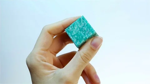 Amazonite is a translucent to opaque feldspar gemstone. Jeweler  Stock Footage 74272350