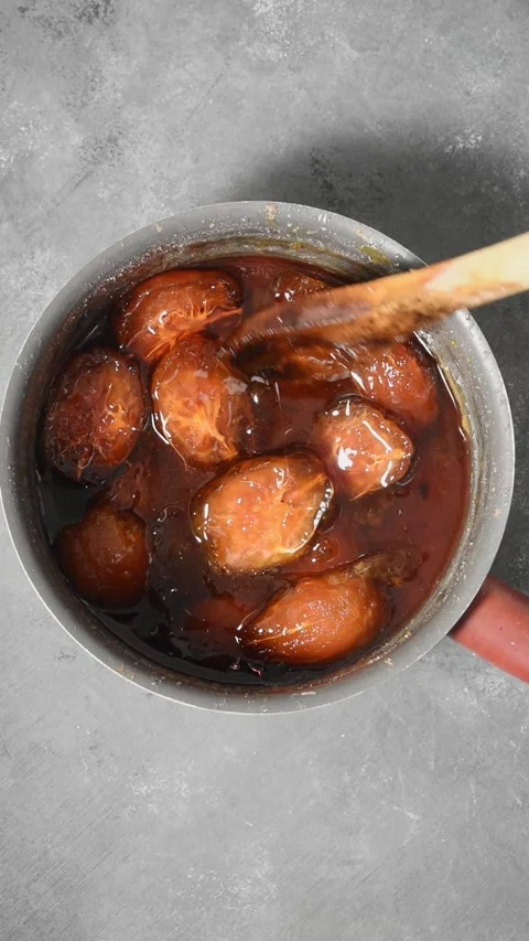 Ambarella or june plum jam or marmalade in pan with wooden spoon, tropical .. Stock Footage 288487023