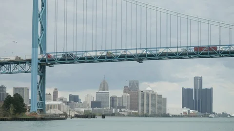 Ambassador Bridge by the Detroit river with downtown Detroit in the backgound Stock Footage