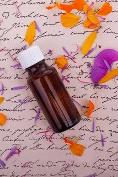 Amber Bottle with Petals on Script. Bach Therapy 写真素材