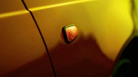 Amber car side turn signal light flashing rhythmically on yellow vehicle Stock-Footage 341802192