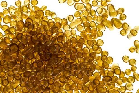 Amber-colored bone glue beads on a white background Stock Photos