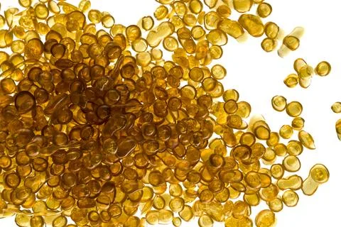 Amber-colored bone glue beads on a white background 스톡 사진