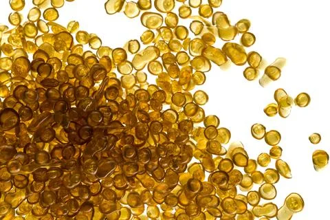 Amber-colored bone glue beads on a white background Stock Photos