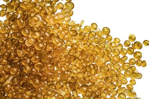 Amber-colored bone glue beads on a white background Stock Photos
