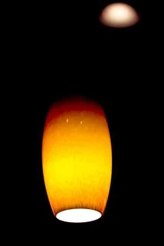 Amber colored hanging ceiling light Stock Photos