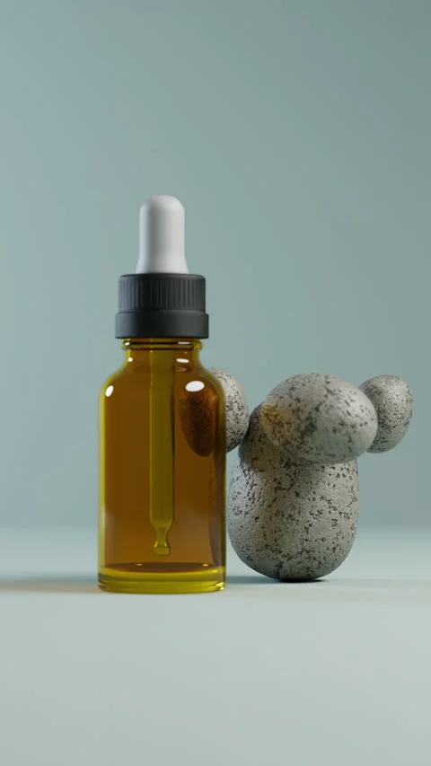 Amber dropper bottle next to balancing stones. Stock Footage 327911316