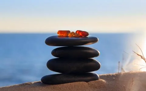 Amber on Flat Pebbles Stock Photos