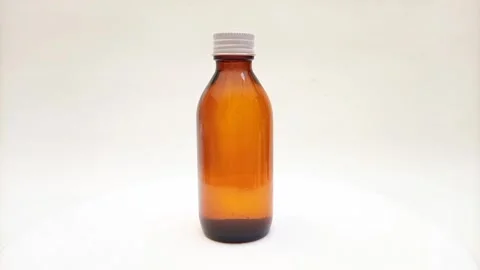 Amber glass bottle with cap rotating on white background, brown glass bottle Stock-Footage 331978555