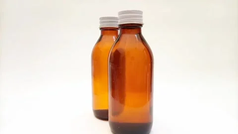 Amber glass bottles with cap rotating on white background, brown glass bottles  스톡 동영상 331978597