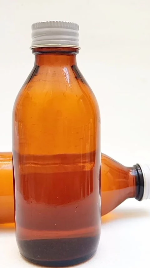 Amber glass bottles with cap rotating on white background, brown glass bottles  Stock Footage 331978773