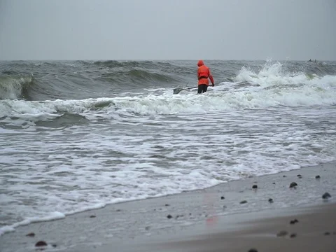 Amber hunter walking in the sea Stock Footage 72901033