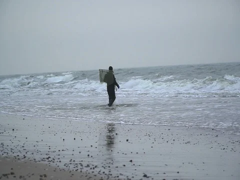 Amber hunter walks into the sea Stock Footage 72901045