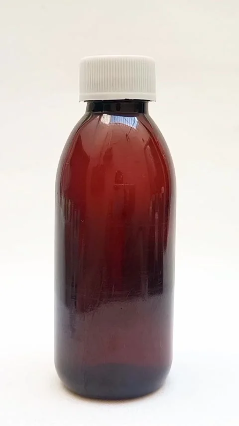 Amber plastic bottle with cap rotating on white background, brown plastic bottle Видео 331978779