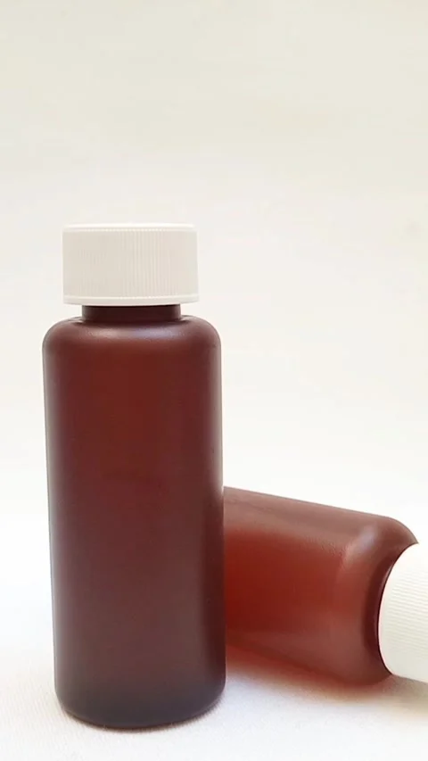 Amber plastic bottles with cap rotating on white background, brown plastic Stock-Footage 331978777