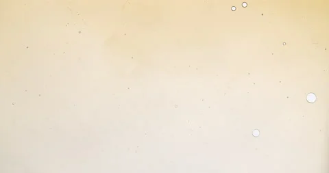 Amber sirup forming abstract forms and patterns Video stock 136258653