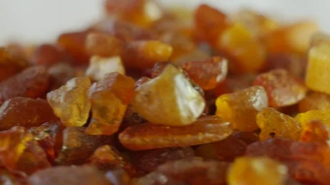 Amber stones on turn table Stock Footage 70565400