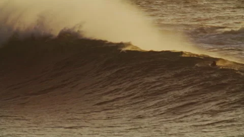 Amber Toned Wave Crashes Over Surfers, Windy Day Stock Footage 317883774