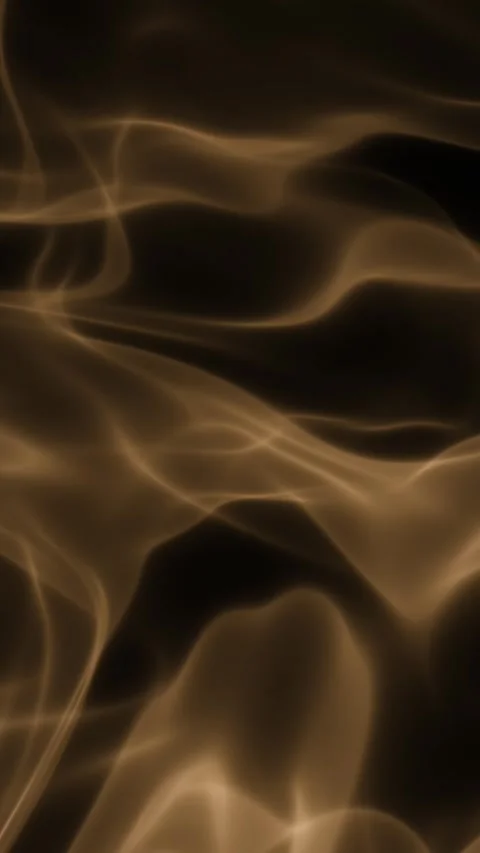 Amber translucent smoke drifts and morphs into fluid patterns against a dark Stock Footage 345184631