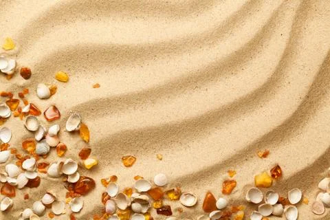 Ambers And Seashells On Sand Background Stock Photos