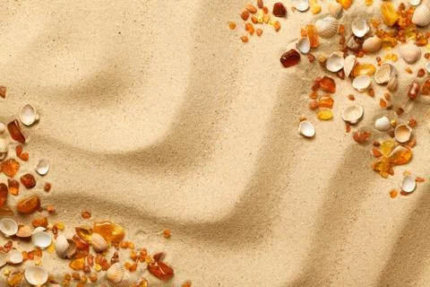 Ambers And Seashells On Sand Background Stock Photos
