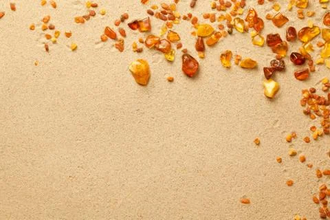 Ambers On Sand Background Stock Photos