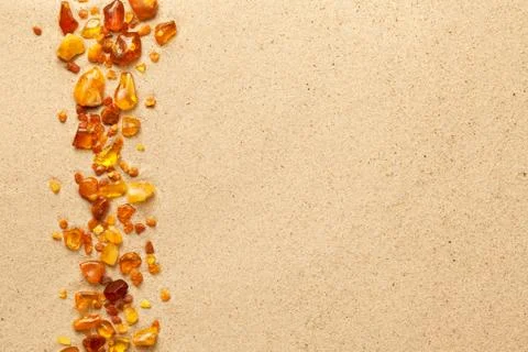 Ambers On Sea Sand Background Stock Photos