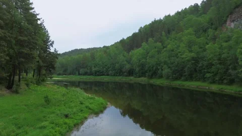 Ambient flying over the river in the wild nature with clouds Stock Footage 246581395