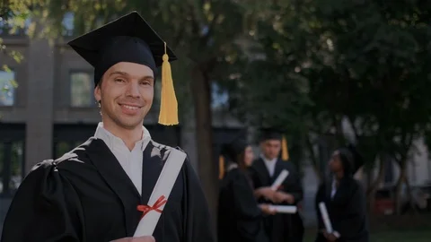 Ambitious adult guy with high intelligence proud of his diploma at graduation Stock Footage 116176761
