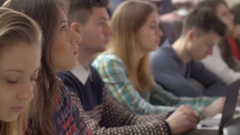 Ambitious and clever students looking at slides in auditorium Stock Footage 69908479