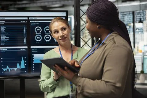 Ambitious career driven multiethnic professionals collaborate over analytics Stock Photos