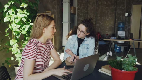 Ambitious enterpreneurs are developing business strategy sitting in modern loft Video stock 88701547