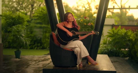 Ambitious girl performing musical composition on guitar Stock Footage 239533070