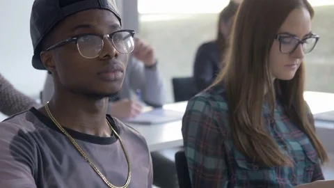 Ambitious mixed-race students looking at the presentation in a classroom 스톡 동영상 69932620