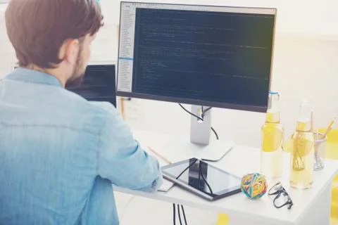 Ambitious programmer working on a computer in an office Stock Photos
