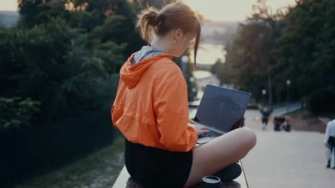 An ambitious student types her college paper on her laptop. Dressed in a bright Video stock 160627865