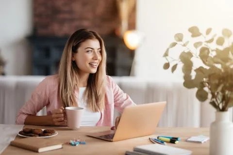 Ambitious young lady beginning her day with smile and coffee Stock Photos