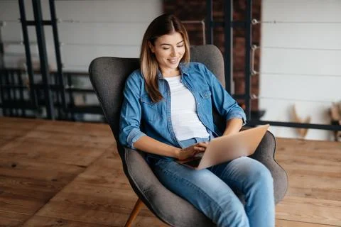 Ambitious young lady using laptop to work from home Stock Photos