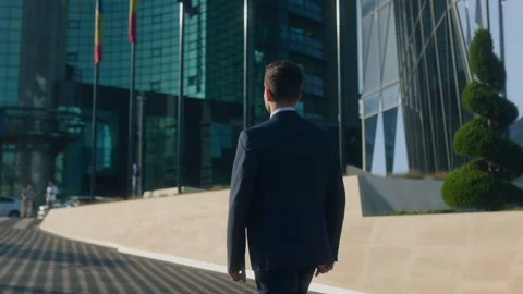 Ambitious young professional in suit walking on modern city street Stock Footage 317976973