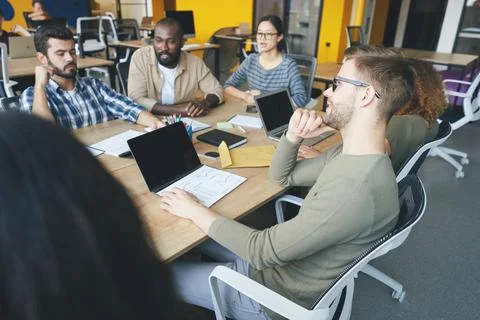 Ambitious youth cooperating while working on a new start-up Stock Photos