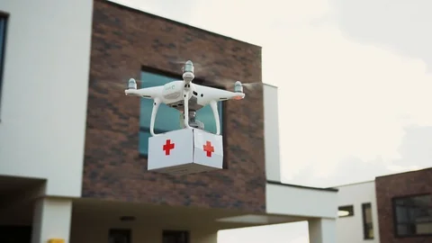 Amblulance drone flying carrying first-aid kit to accident spot in the street Stock Footage 113799493