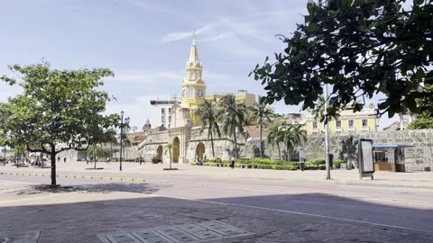 Ambulance and Buses passing by the clock tower in Cartagena, Colombia Stock Footage 290967584