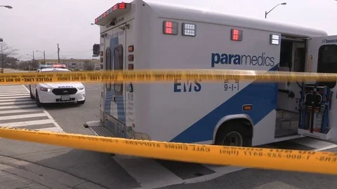 Ambulance and police at scene of deadly pedestrian accident in intersection Stock Footage