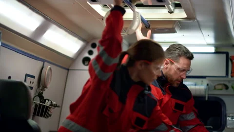 Ambulance crew going for traffic accident. Paramedic doctors preparing stretcher Stock Footage 166904253