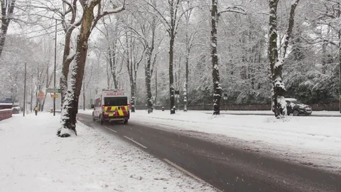 Ambulance Driving Down Main Road in Icey Conditions 库存影片 83275318