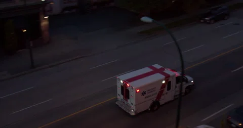 Ambulance driving down the road Stock Footage 130292135